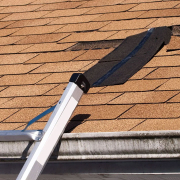 Ladder leading to missing shingles on roof