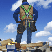 An image of a construction worker inspecting a roof, preparing for a roof replacement.