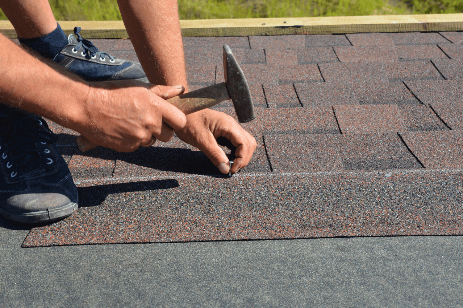 An overview image of a house being shingled, illustrating the process of roof installation. 