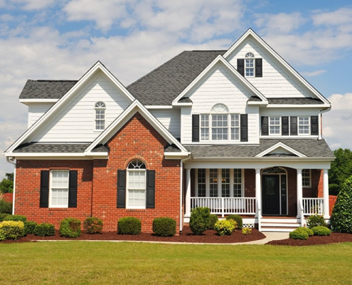 White-siding-and-brick-home-multiple-windows