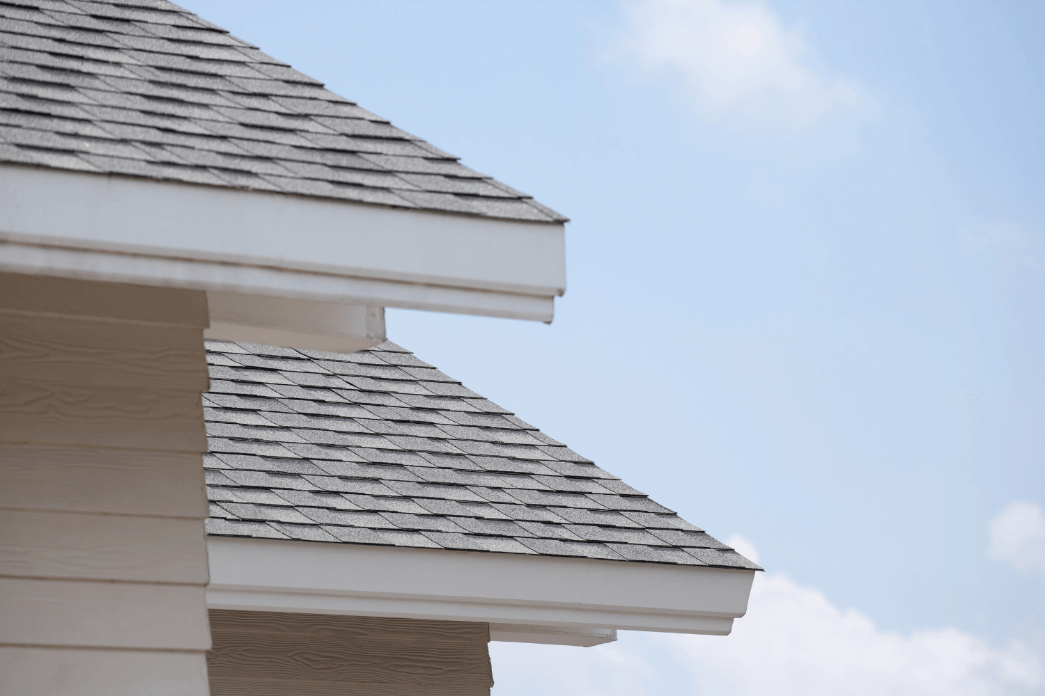 A homeowner inspecting their roof, focusing on maintenance tips for Owens Corning shingles. 