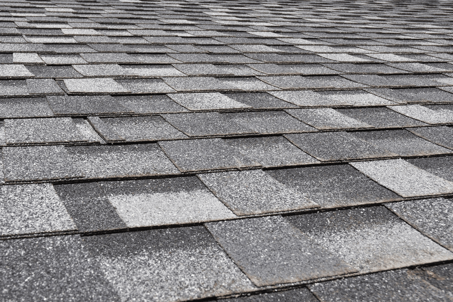 An array of Owens Corning roofing shingles displayed in various colors and styles. 