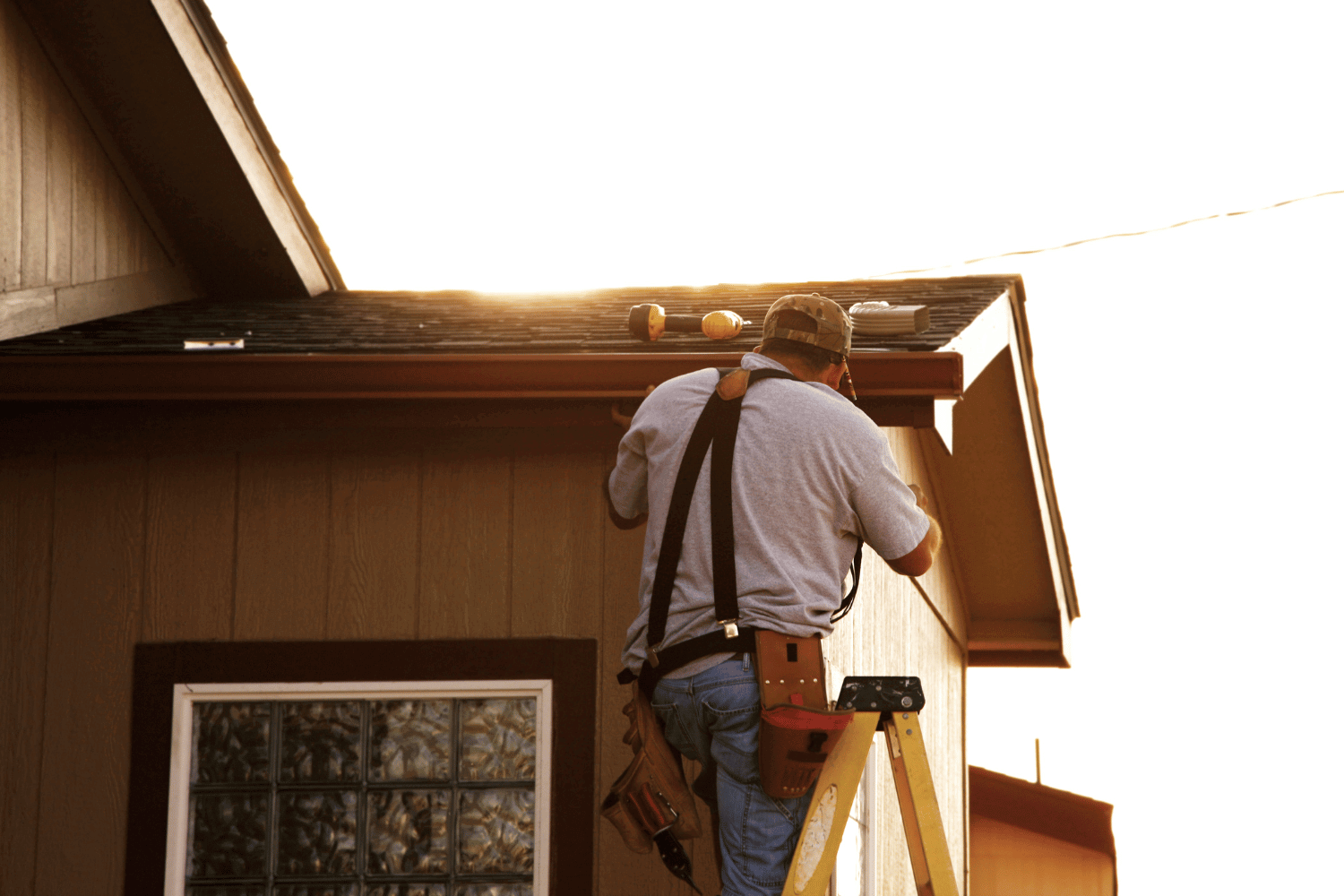 Different types of gutters installed on a house, showcasing seamless and traditional styles. 