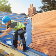 A demonstration of replacing a damaged shingle on a roof.