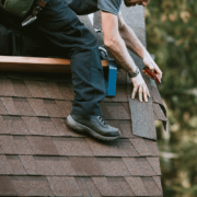 A roofing contractor installing 30-year shingles on a home.