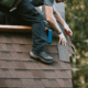 A roofing contractor installing 30-year shingles on a home.