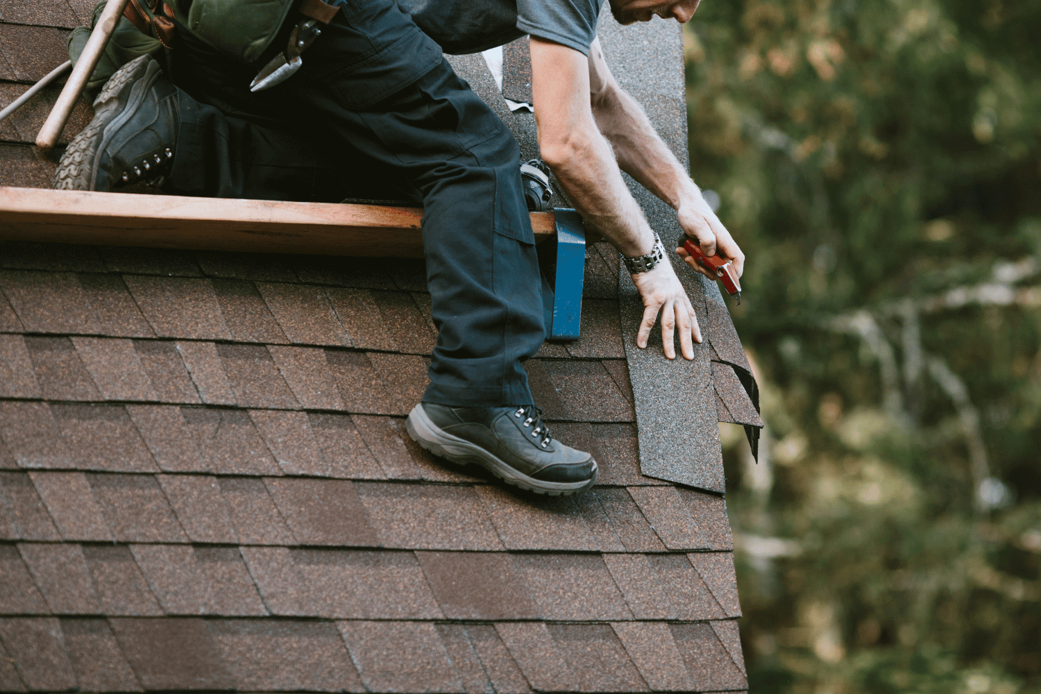 A roofing contractor installing 30-year shingles on a home.