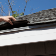 A detailed view of shingle roof components including underlayment and drip edge.