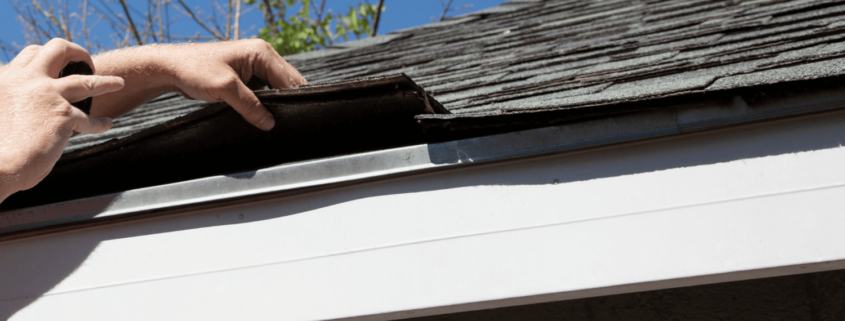 A detailed view of shingle roof components including underlayment and drip edge.