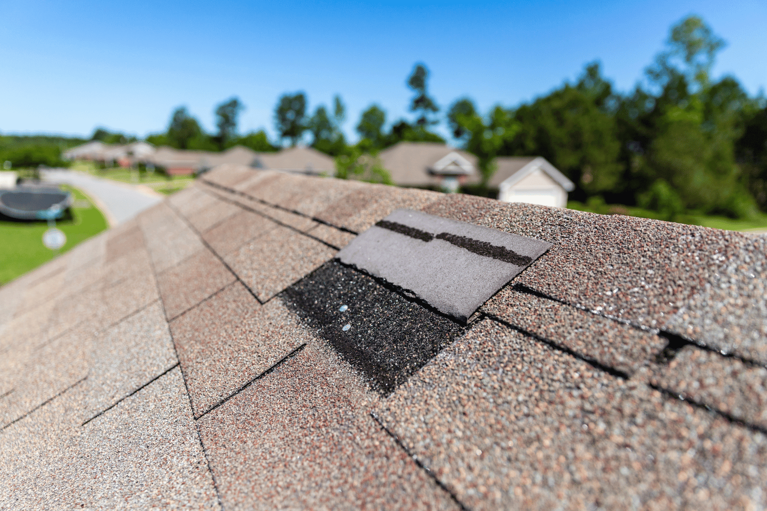 A house with a visibly damaged roof indicating the need for a roof replacement.