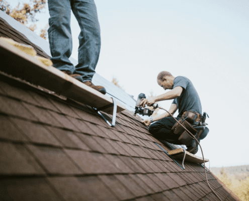 A roofing contractor conducting a final inspection of a newly installed roof.