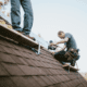A roofing contractor conducting a final inspection of a newly installed roof.