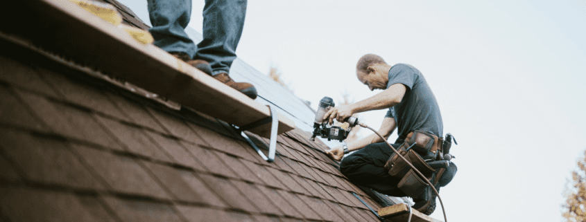 A roofing contractor conducting a final inspection of a newly installed roof.