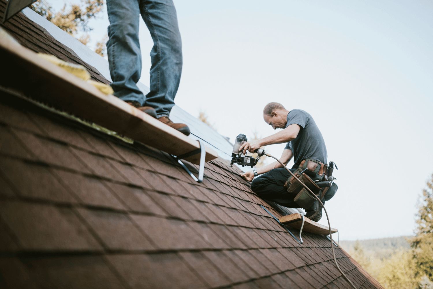 A roofing contractor conducting a final inspection of a newly installed roof.