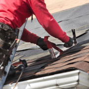 Installation of new roofing materials on a residential building.