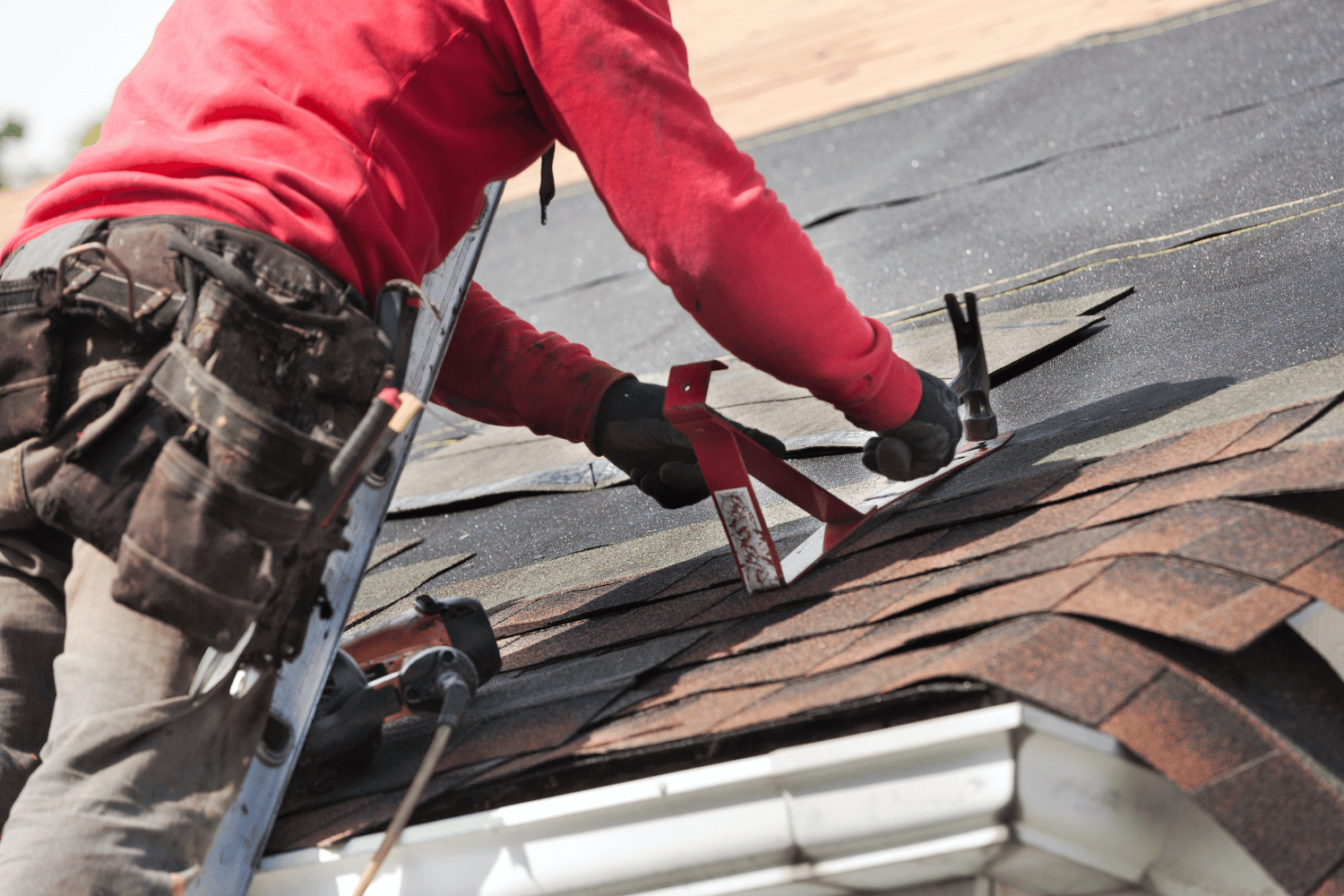 Installation of new roofing materials on a residential building. 